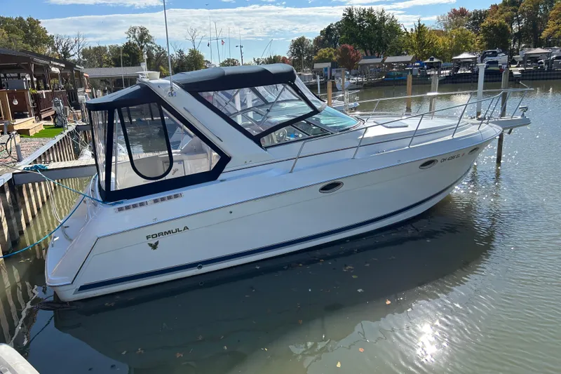 The Image of 1999 Formula 31 Performance Cruiser docked in a serene marina setting. - 0