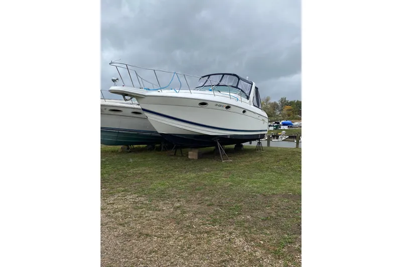 Slide: The Image of 1999 Formula 31 Performance Cruiser boat on land, overcast sky background. - 6
