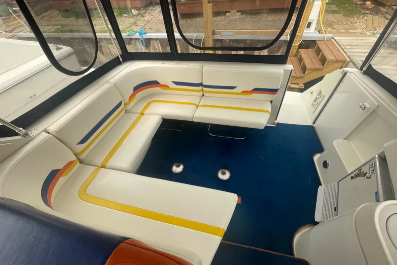 Slide: The Image of 1999 Formula 31 Performance Cruiser interior with colorful seating and blue carpet. - 10