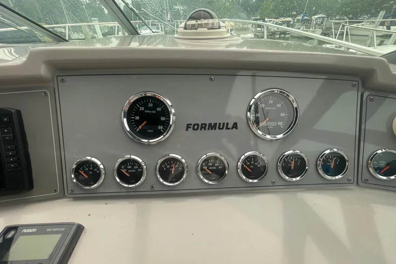 Slide: The Image of Dashboard of a 1999 Formula 31 Performance Cruiser with gauges and controls. - 13