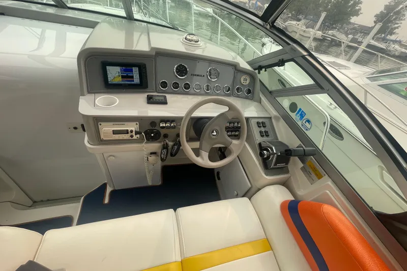 Slide: The Image of Cockpit of 1999 Formula 31 Performance Cruiser with steering wheel and navigation instruments. - 15