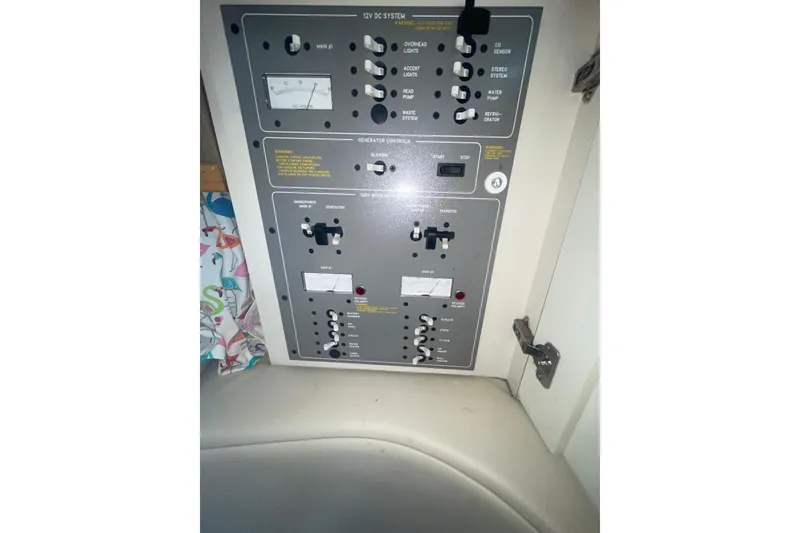 Slide: The Image of Control panel of a 1999 Formula 31 Performance Cruiser, featuring various switches and gauges. - 35