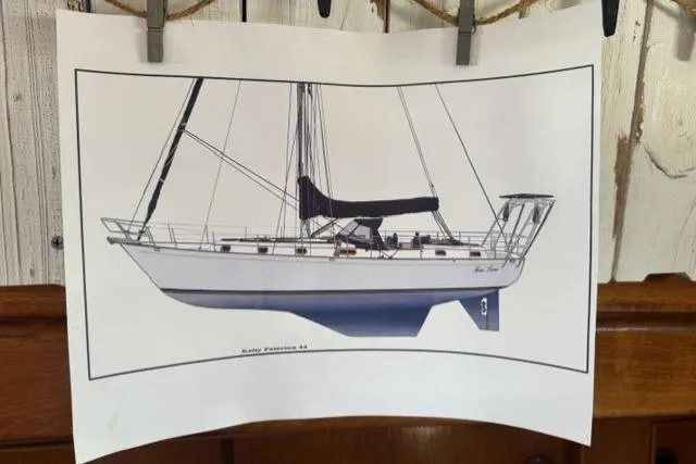 Slide: The Image of Illustration of a 1977 Kelly Peterson 44 sailboat, displayed on a wooden wall. - 39