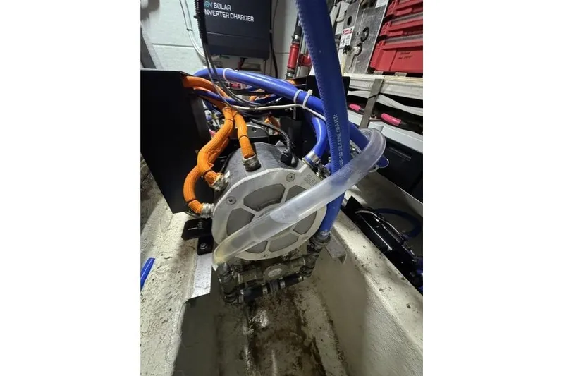Slide: The Image of Engine compartment of a 1976 Kelly Peterson 44 sailboat with visible hoses and wiring. - 27