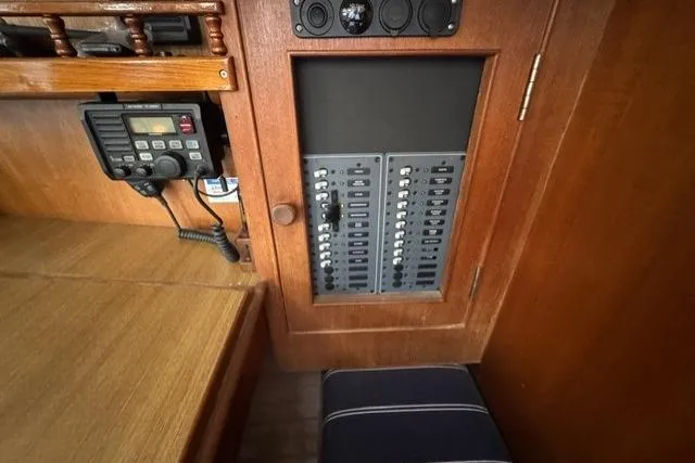 Slide: The Image of Electrical panel and radio equipment inside a 1977 Kelly Peterson 44 sailboat cabin. - 19