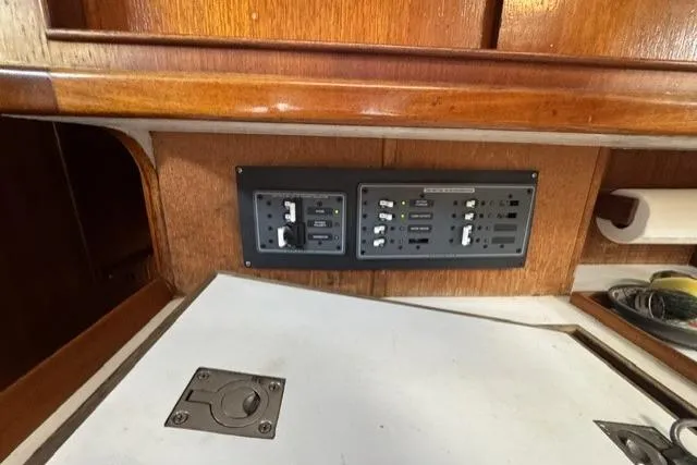 Slide: The Image of Electrical panel on a 1977 Kelly Peterson 44 sailboat with wooden interior. - 21