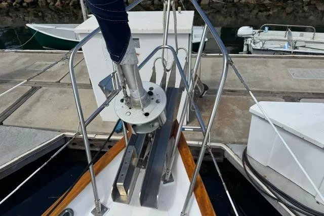 Slide: The Image of Bow of a 1977 Kelly Peterson 44 sailboat docked at a marina. - 34