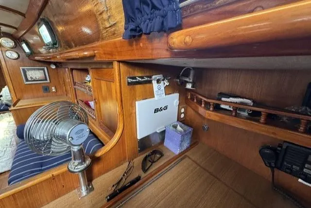 Slide: The Image of Interior of a 1977 Kelly Peterson 44 sailboat with wooden cabinetry and nautical equipment. - 18