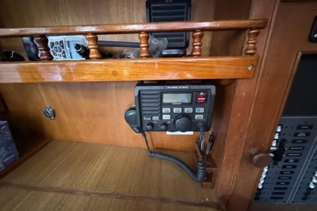 Slide: The Image of Marine radio equipment on a 1977 Kelly Peterson 44 sailboat, mounted on a wooden panel. - 20