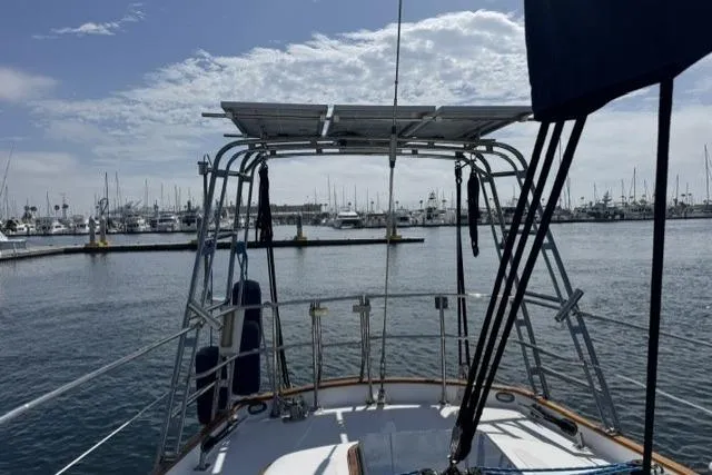 Slide: The Image of Sailboat deck view of a 1977 Kelly Peterson 44 in a marina setting. - 3