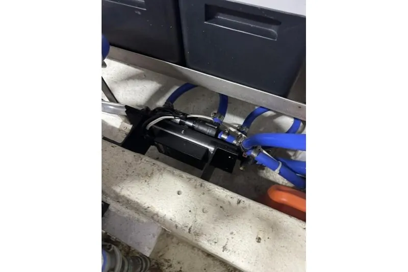 Slide: The Image of Engine compartment of a 1976 Kelly Peterson 44 sailboat with blue hoses and wiring. - 28