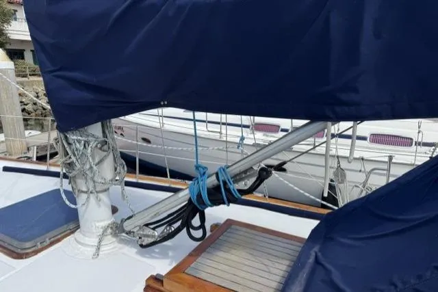 Slide: The Image of Sailboat deck of 1977 Kelly Peterson 44, featuring rigging and covered boom. - 33