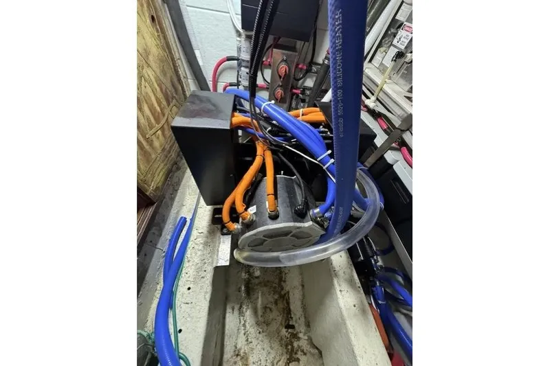 Slide: The Image of Engine compartment of a 1976 Kelly Peterson 44 sailboat with visible hoses and wiring. - 29