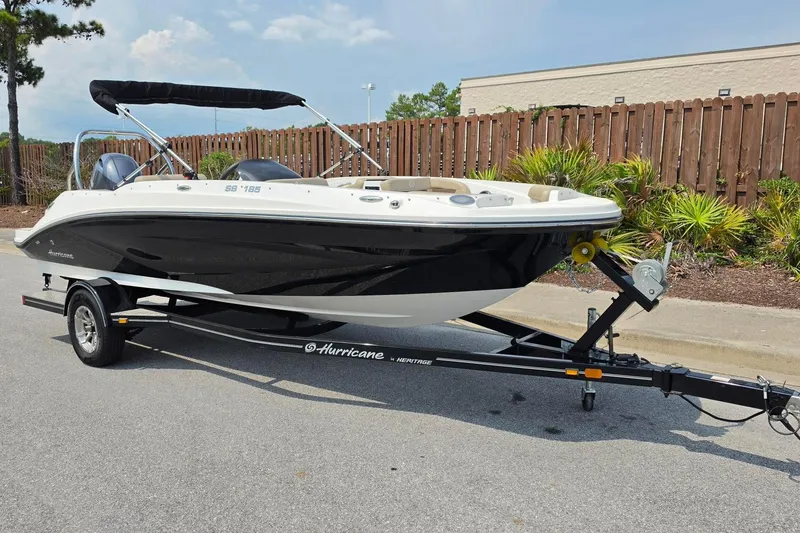 Slide: The Image of 2022 Hurricane SunDeck Sport 185 OB boat on trailer, parked on a street. - 11