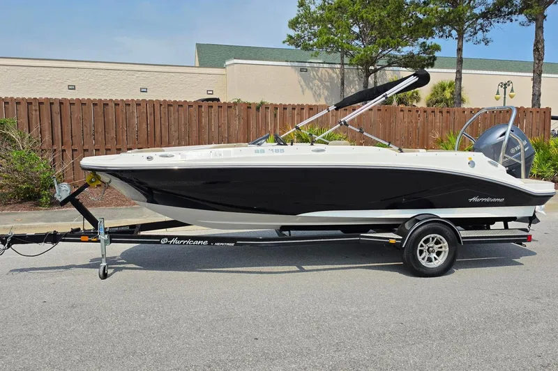 Slide: The Image of 2022 Hurricane SunDeck Sport 185 OB boat on trailer, parked outdoors. - 9
