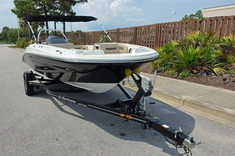 Slide: The Image of 2022 Hurricane SunDeck Sport 185 OB boat on trailer, parked on a sunny street. - 15