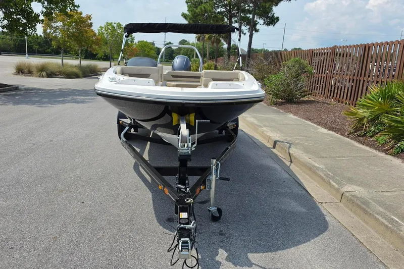 Slide: The Image of 2022 Hurricane SunDeck Sport 185 OB boat on trailer, parked in a lot. - 13