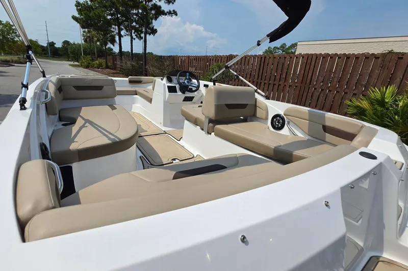 Slide: The Image of 2022 Hurricane SunDeck Sport 185 OB boat interior with beige seating and steering console. - 5