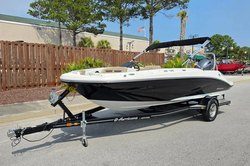 Slide: The Image of 2022 Hurricane SunDeck Sport 185 OB boat on trailer, parked outdoors. - 10