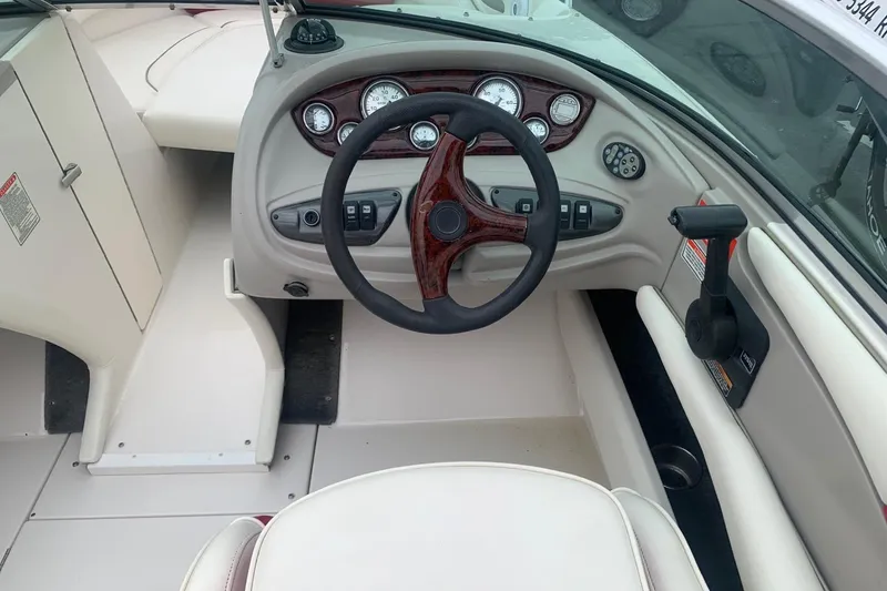 Slide: The Image of 2003 Monterey 228SI Montura Bowrider dashboard with steering wheel and control panel. - 6