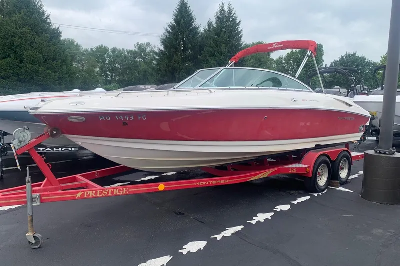 The Image of 2003 Monterey 228SI Montura Bowrider on red trailer, parked outdoors. - 1