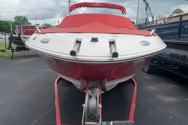 Slide: The Image of 2003 Monterey 228SI Montura Bowrider with red cover on trailer, parked outdoors. - 3
