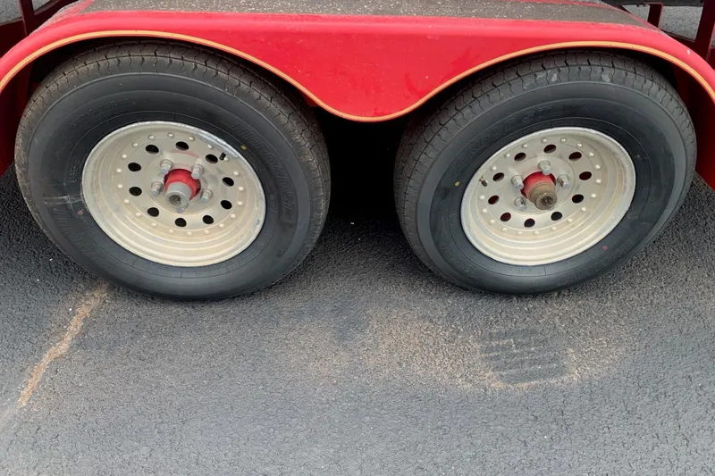 Slide: The Image of Red trailer wheels for 2003 Monterey 228SI Montura Bowrider on asphalt surface. - 10