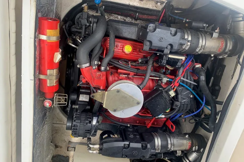 Slide: The Image of Engine compartment of a 2003 Monterey 228SI Montura Bowrider, featuring a red engine and components. - 11