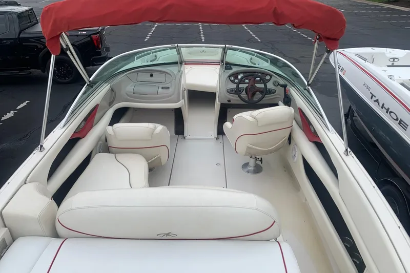 Slide: The Image of 2003 Monterey 228SI Montura Bowrider with red canopy and white interior seating. - 5