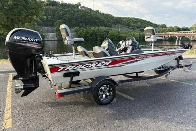 Slide: The Image of 2018 Tracker Pro Team 195 TXW 40th Anniversary Edition boat with Mercury engine, parked by a river. - 5