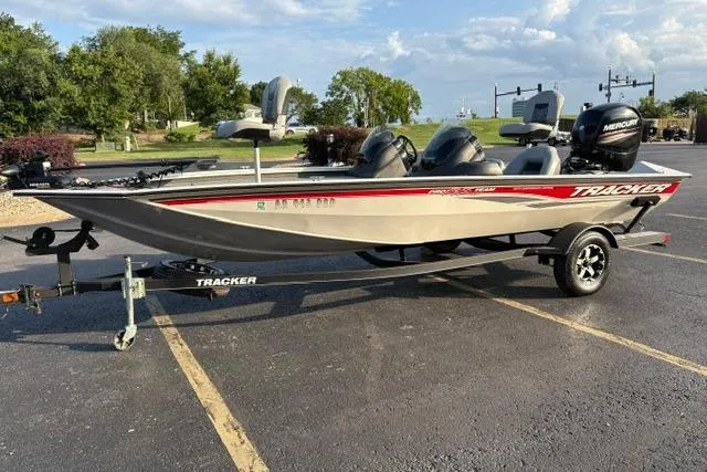 Slide: The Image of 2018 Tracker Pro Team 195 TXW 40th Anniversary Edition boat on trailer in parking lot. - 11