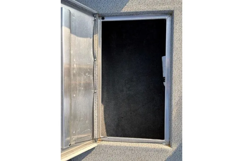 Slide: The Image of Open storage compartment on 2018 Tracker Pro Team 195 TXW boat. - 36