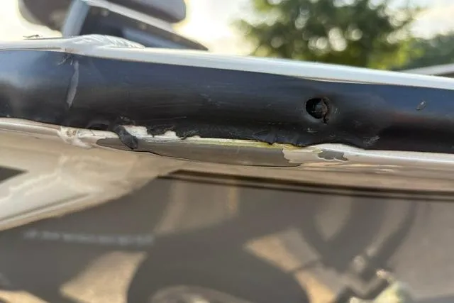 Slide: The Image of Damaged edge of 2018 Tracker Pro Team 195 TXW boat, showing wear and tear. - 48