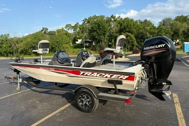 Slide: The Image of 2018 Tracker Pro Team 195 TXW 40th Anniversary Edition boat with Mercury engine in parking lot. - 6