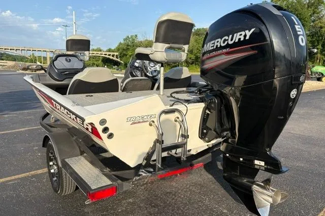 Slide: The Image of 2018 Tracker Pro Team 195 TXW boat with Mercury 150 engine, parked outdoors. - 12