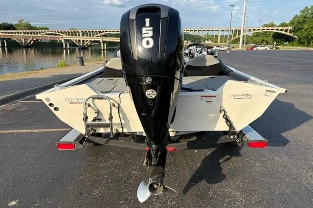 Slide: The Image of 2018 Tracker Pro Team 195 TXW boat with 150 HP engine, parked near a river. - 17
