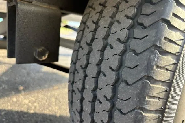 Slide: The Image of Close-up of a tire on a 2018 Tracker Pro Team 195 TXW boat trailer. - 50