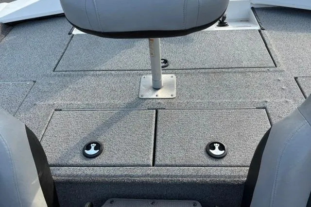Slide: The Image of 2018 Tracker Pro Team 195 TXW boat interior with gray seating and storage compartments. - 20