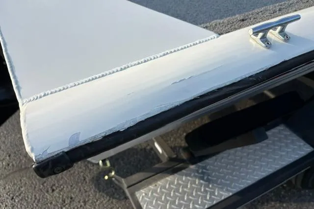Slide: The Image of 2018 Tracker Pro Team 195 TXW boat edge with wear, featuring a cleat and diamond plate step. - 49
