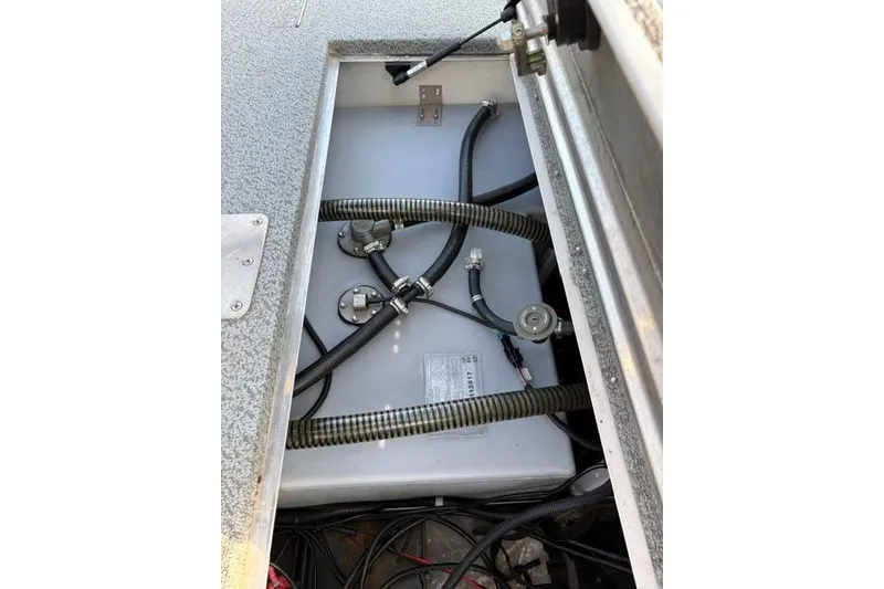 Slide: The Image of 2018 Tracker Pro Team 195 TXW boat's internal compartment with hoses and wiring. - 22