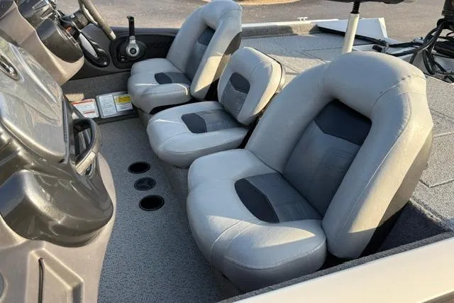 Slide: The Image of 2018 Tracker Pro Team 195 TXW boat interior with gray seating, steering console, and cup holders. - 41