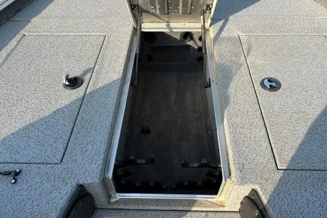 Slide: The Image of 2018 Tracker Pro Team 195 TXW boat storage compartment open, showcasing interior space. - 35