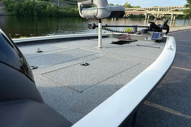 Slide: The Image of 2018 Tracker Pro Team 195 TXW boat docked by a scenic river with bridge view. - 18