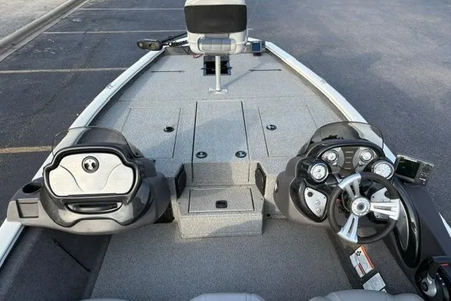 Slide: The Image of 2018 Tracker Pro Team 195 TXW boat interior with steering console and seating. - 24
