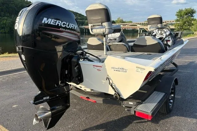Slide: The Image of 2018 Tracker Pro Team 195 TXW boat with Mercury engine, parked near a scenic lake. - 16