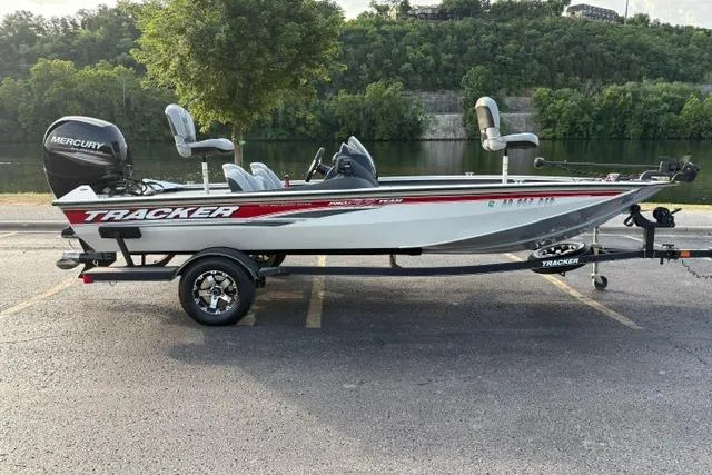 Slide: The Image of 2018 Tracker Pro Team 195 TXW 40th Anniversary Edition boat on trailer by a river. - 3