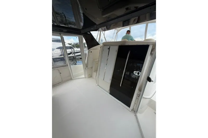 Slide: The Image of Interior view of 2012 Carver 41 Cockpit Motor Yacht with glass doors and seating area. - 39