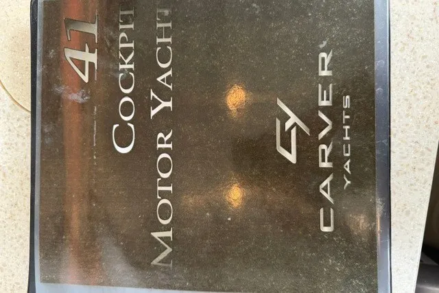 Slide: The Image of Carver 41 Cockpit Motor Yacht 2012 brochure cover with logo and text. - 45