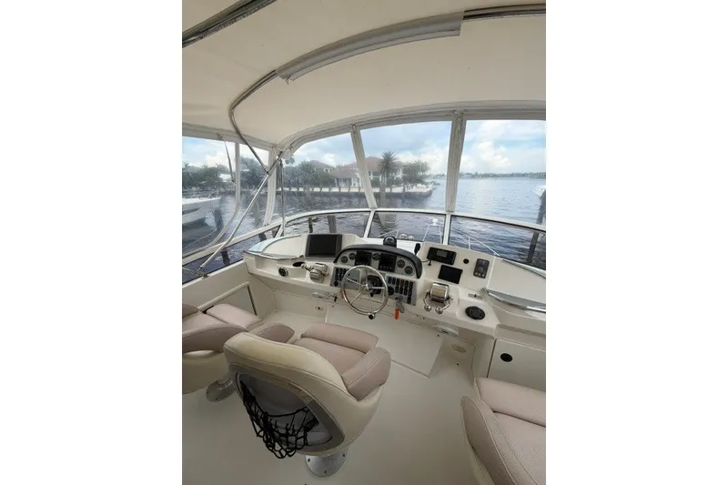 Slide: The Image of Interior view of 2012 Carver 41 Cockpit Motor Yacht helm with water view. - 12