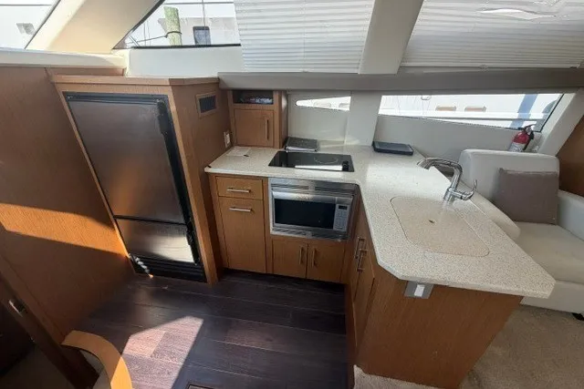 Slide: The Image of Interior of 2012 Carver 41 Cockpit Motor Yacht with modern kitchen amenities. - 9